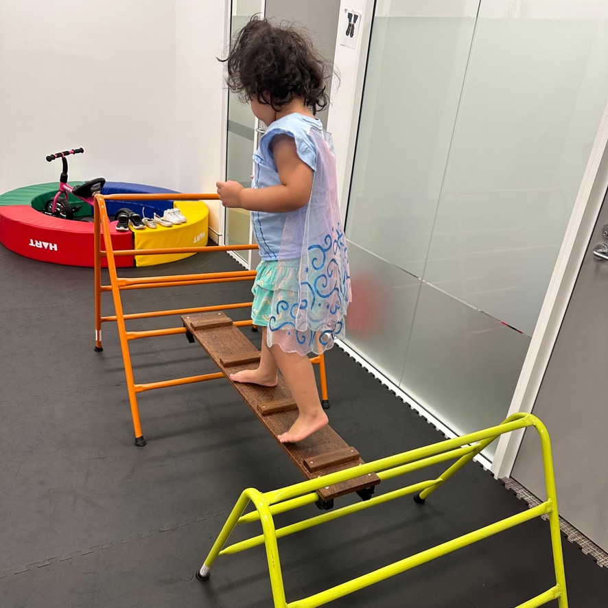 Young girl learning to balance in Occupational Therapy session