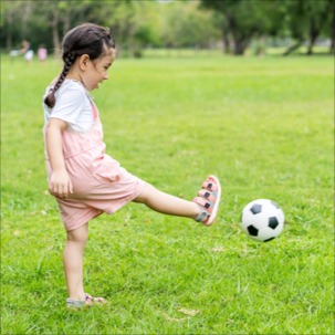 Young girl learning to kick a ball using Occupational therapy for coordination issues in bondi junction and mascot